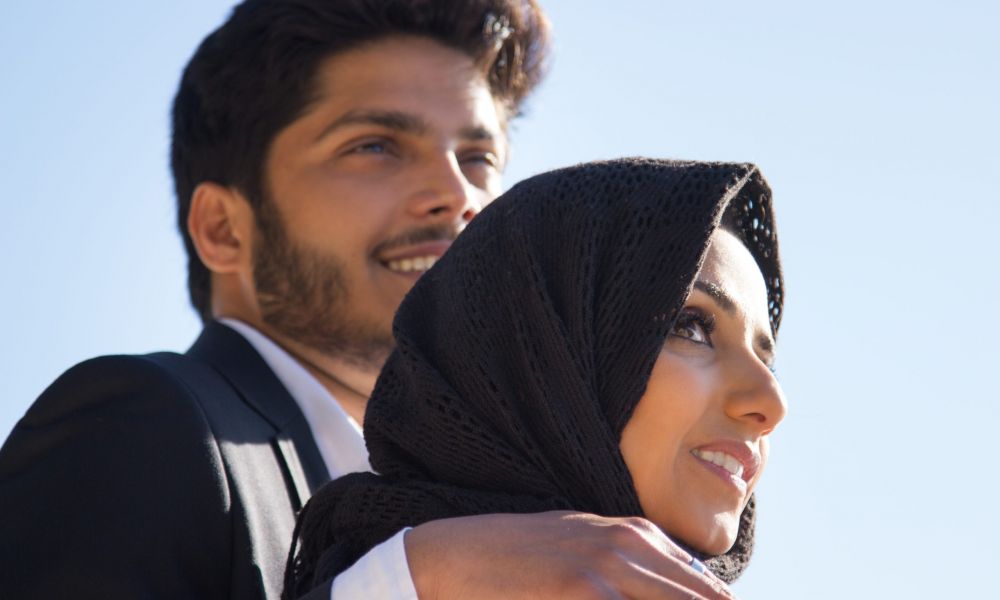 Side View Young Romantic Couple Attractive Muslim Woman Black Headscarf Handsome Dark Haired Man Embracing Her Standing Close Looking Far Away Romance Relationship Concept Scaled | Understanding Updated Dubai Marriage Laws: A Guide For Couples In 2025 | Navigating Dubai Marriage Laws? Simplified 2025 Rules Make Weddings Stress-Free And Inclusive. Dubai marriage laws