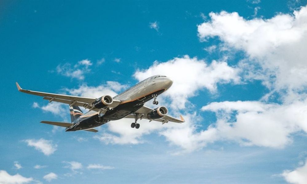 Bahrain Residents Can Now Get Married In Seychelles Despite Covid.jpg | Uae Neighbours Bahrain Residents Can Now Get Married In Seychelles | If You Are A Foreigner Living In Dubai And Want To Get Married, Then You Are In The Right Place. You Would Also Already Know That Getting Married In Dubai Is One Of The Most Daunting Tasks Ever. From The Long List Of Requirements To High Costs, Everything Is Challenging. So Many Uae Residents Opt For Getting Married In Seychelles. And From Today Onwards Even Our Neighbour Country Bahrain Can Get Married In Seychelles Too! Yes, You Heard It Right. The Government Of Seychelles Has Opened Its Borders For You. Now You Can Easily Travel To Seychelles To Get Married. An airplane soars through a clear blue sky with fluffy white clouds. The aircraft's metallic body shines brightly under the sunlight while showing its tail branding. This image illustrates travel and exploration, inviting viewers to imagine convenient flights to beautiful destinations like Dubai and Abu Dhabi for their dream weddings.