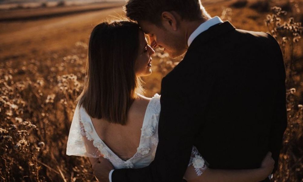 What Are The Papers Required To Get Married In Georgia For Dubai Expats 46B620B8 | What Are The Papers Required To Get Married In Georgia For Dubai Expats | If You Are Living In Dubai; You Might Have Figured Out By Now; That Getting Married Here Is Not Easiest. This Is True, Especially For Those Couples Who Belong To Different Nationalities And Religion. A couple shares a peaceful moment in a sunlit field during their wedding ceremony. The woman feels lovely in her white lace dress, while the man wears a dark suit. They are surrounded by gentle wildflowers, creating a romantic atmosphere filled with warmth and love. This image captures the essence of love and togetherness as they enjoy each other's company during this unforgettable day in beautiful Dubai.