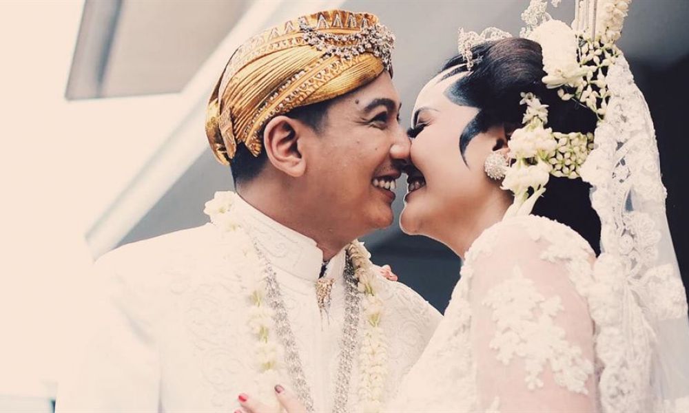 Acbc7964 | Can You Get Married In Dubai Despite Having Different Religions? | With The Rapid Growth Of Foreigners Coming To The Uae, Famously Being An Islamic Country, The Rise Of Interfaith Relationships Has Gone Up. Dubai, Which Follows Islamic Law, Is Quite Keen About Expats Following The Laws Of The City, So We’re Here To Provide Information If You And Your Partner Want To Get Married With Different Faiths. A joyful couple dressed in traditional wedding attire shares a loving moment on their special day surrounded by symbols of celebration and unity.