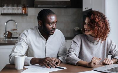 couple planning a wedding in Dubai without a fixed date using laptop and documents