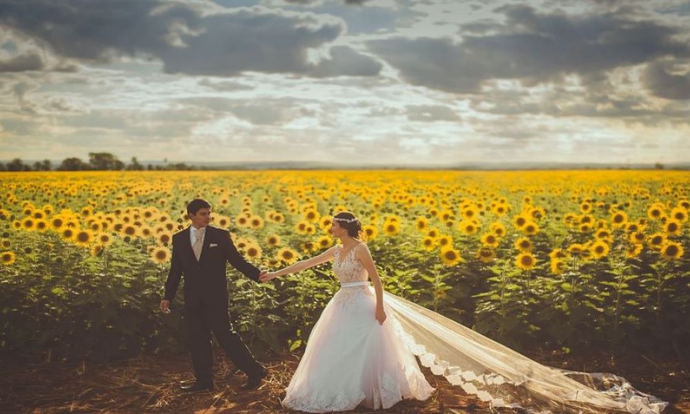 Ec9F46Ed | Wedding Package To Easily Get Married In Georgia If Dubai Is Not The Right Option For You | Getting Married In Dubai Is One Of The Most Daunting Tasks. Not Only Does It Require Much Effort But It Also Takes A Lot Of Time. That’s Why We Have Compiled This Article Today That Will Allow You To Choose The Best Wedding Packages In Georgia To Easily Get Married. Keep On Reading To Find Out The Packages That Suit You The Best For Wedding In Georgia. A happy couple celebrating their wedding in Dubai surrounded by beautiful flowers and decorations. They are smiling at each other under a stunning archway designed for weddings. The atmosphere is filled with joy and love, showcasing an ideal setting for a memorable marriage event. It's a perfect example of what a joyous relationship can bring to life in Dubai's magical environment.